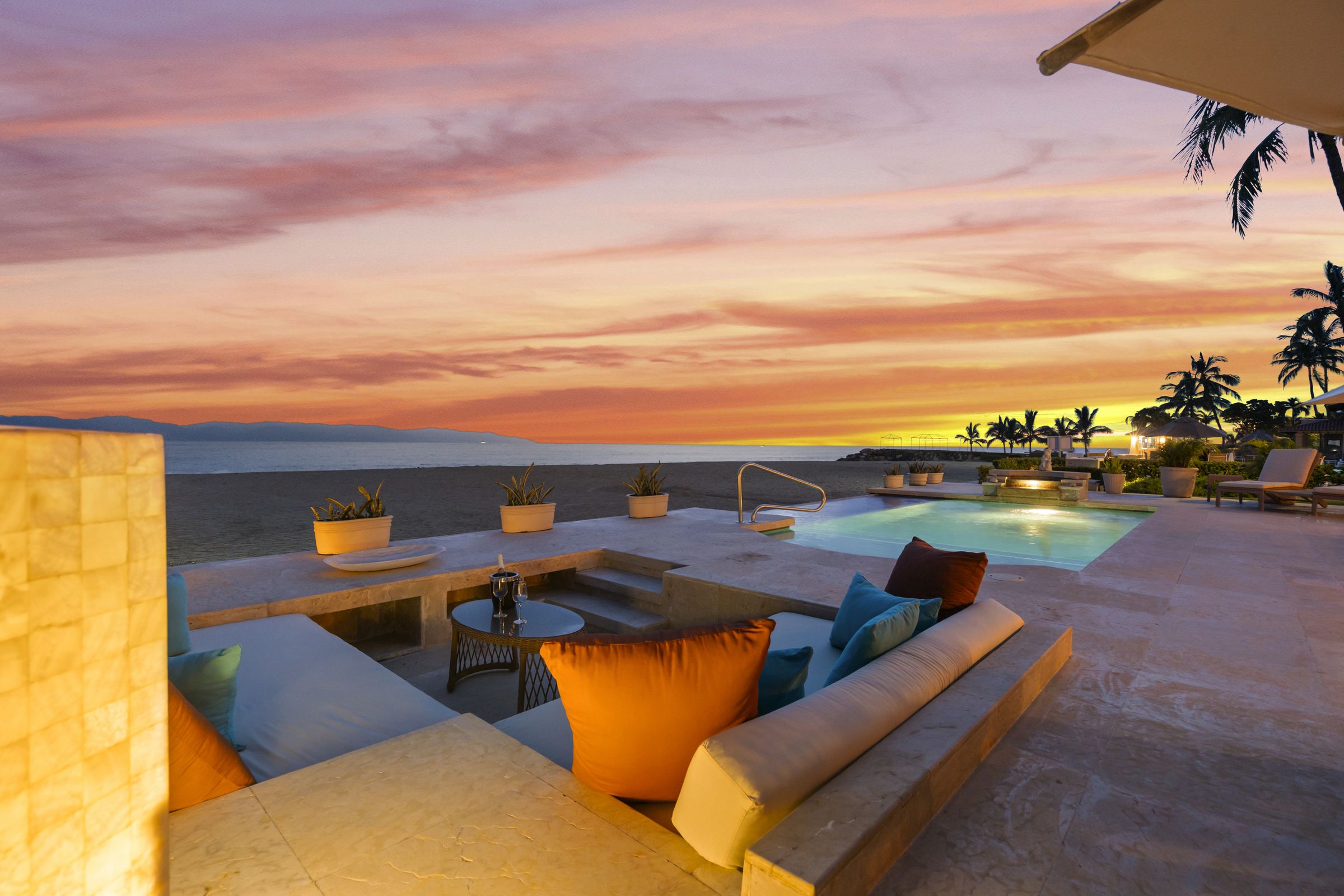 Sunset over Banderas Bay from the sunken lounge and pool terrace of Villa Caracoles 1A, on the beach in Marina Vallarta