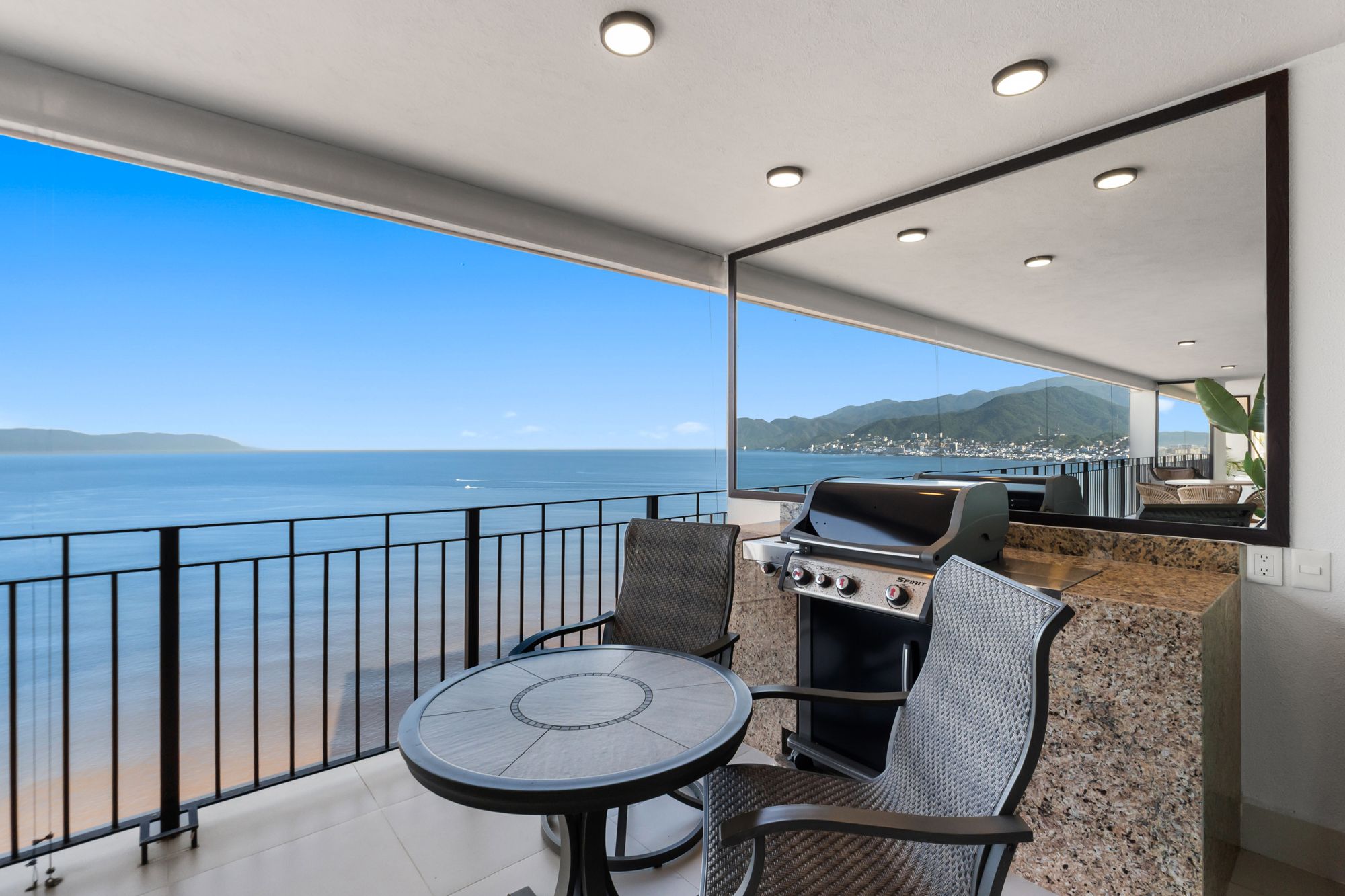 Terrace grill and bistro table overlooking the ocean