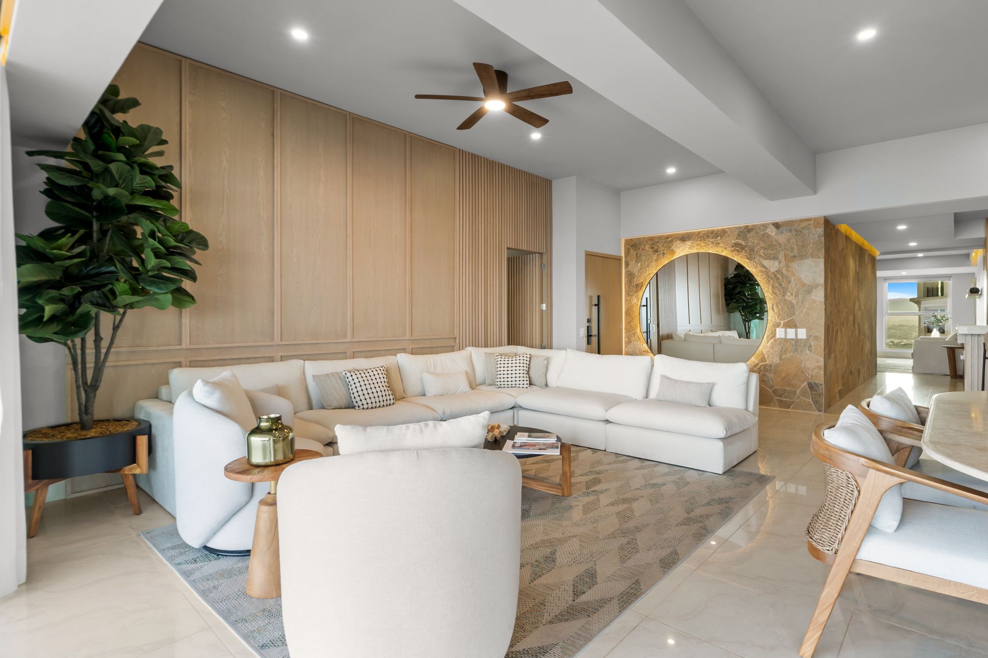 Living room with oak wall paneling and a backlit stone archway