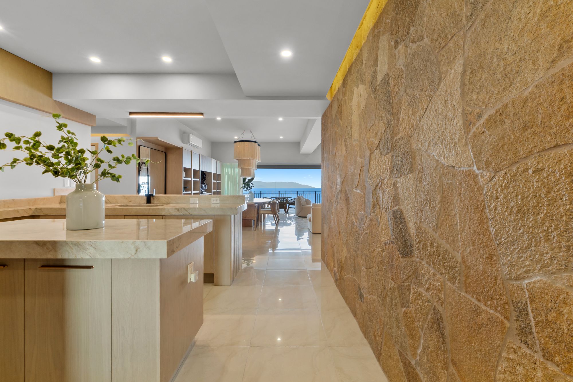 Stone feature wall leading from the kitchen to the ocean view