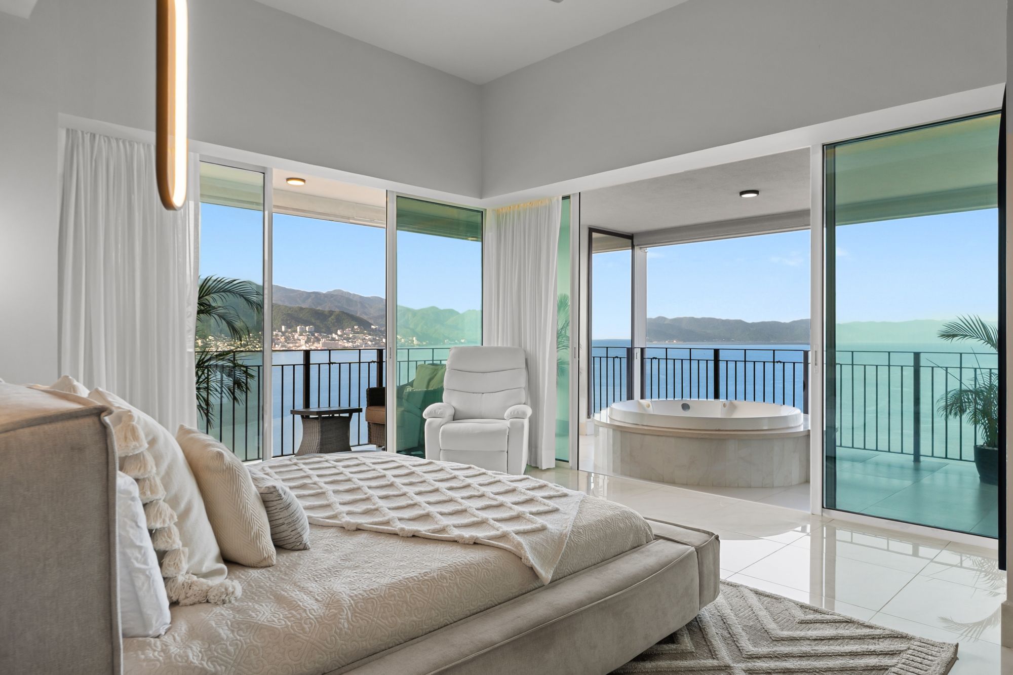 Primary suite with wraparound glass, ocean views and a jacuzzi on its terrace