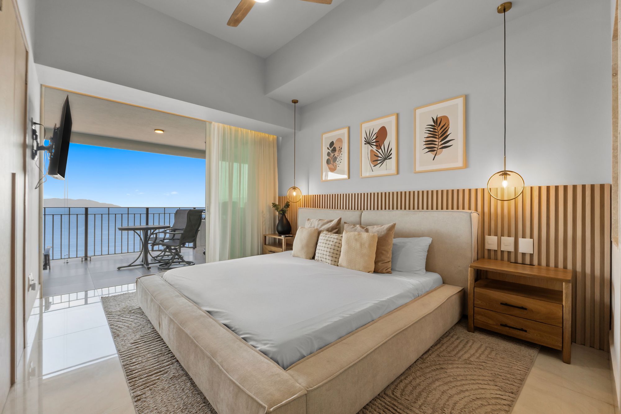 Second bedroom with a king bed and a balcony facing the bay