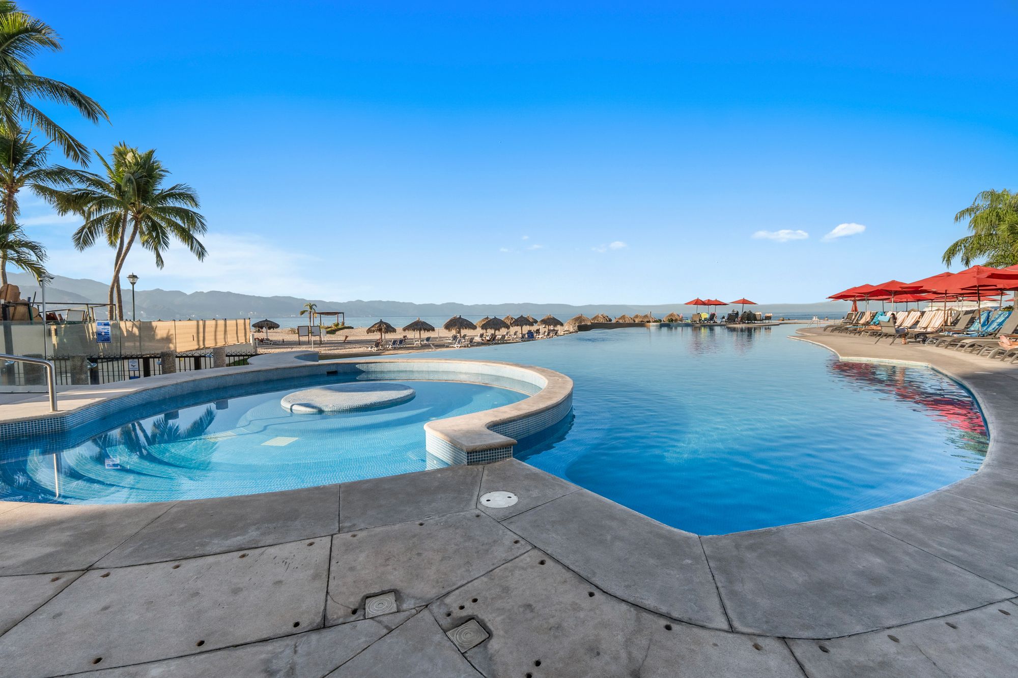 Pool terraces facing the beach and Banderas Bay