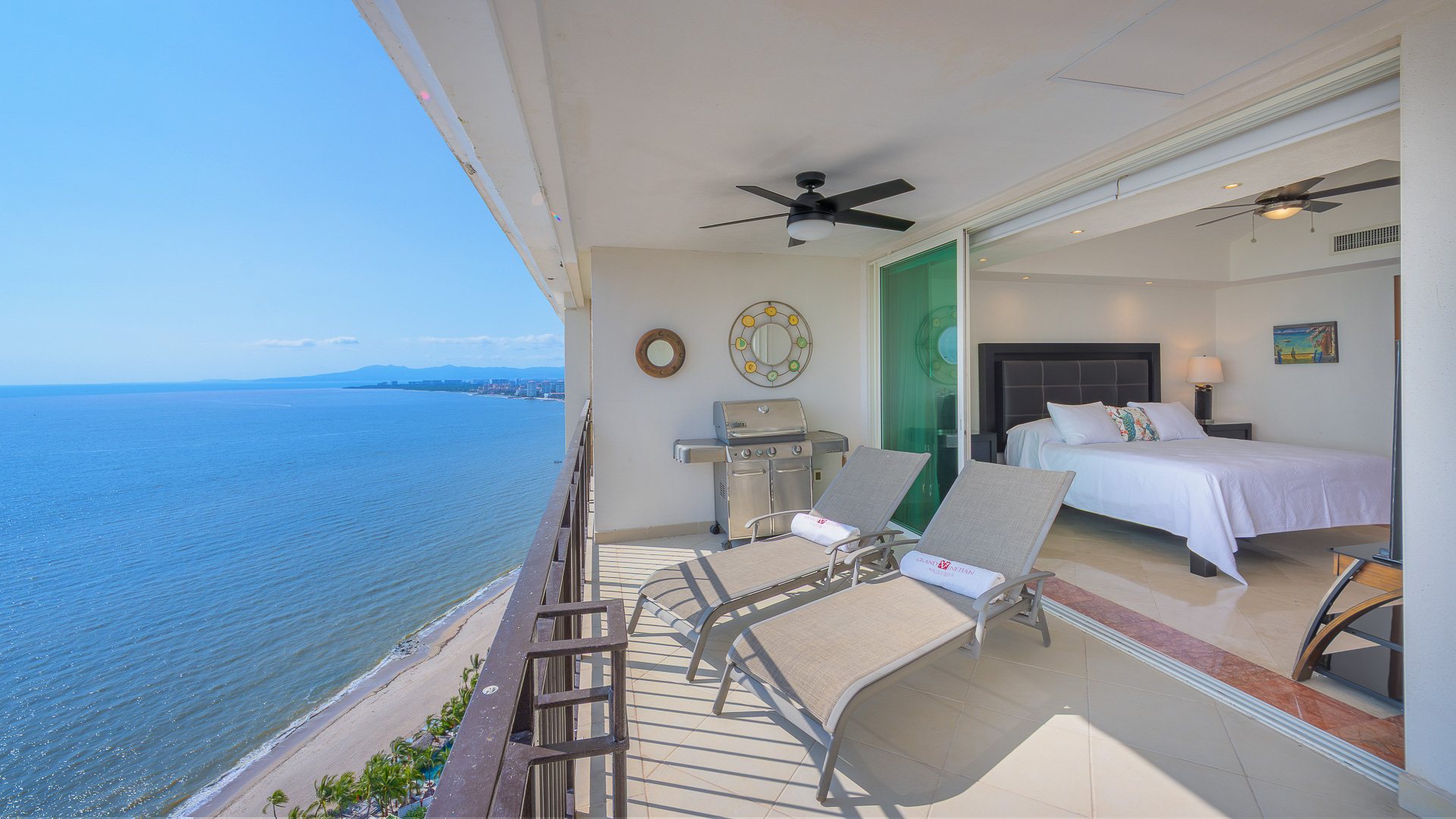 Sun loungers and grill along the terrace, with the beach far below