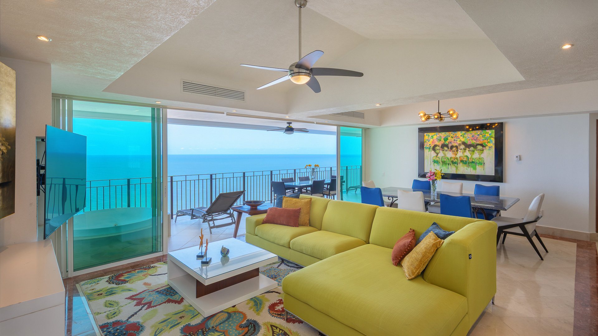 Great room with glass doors open to the ocean terrace