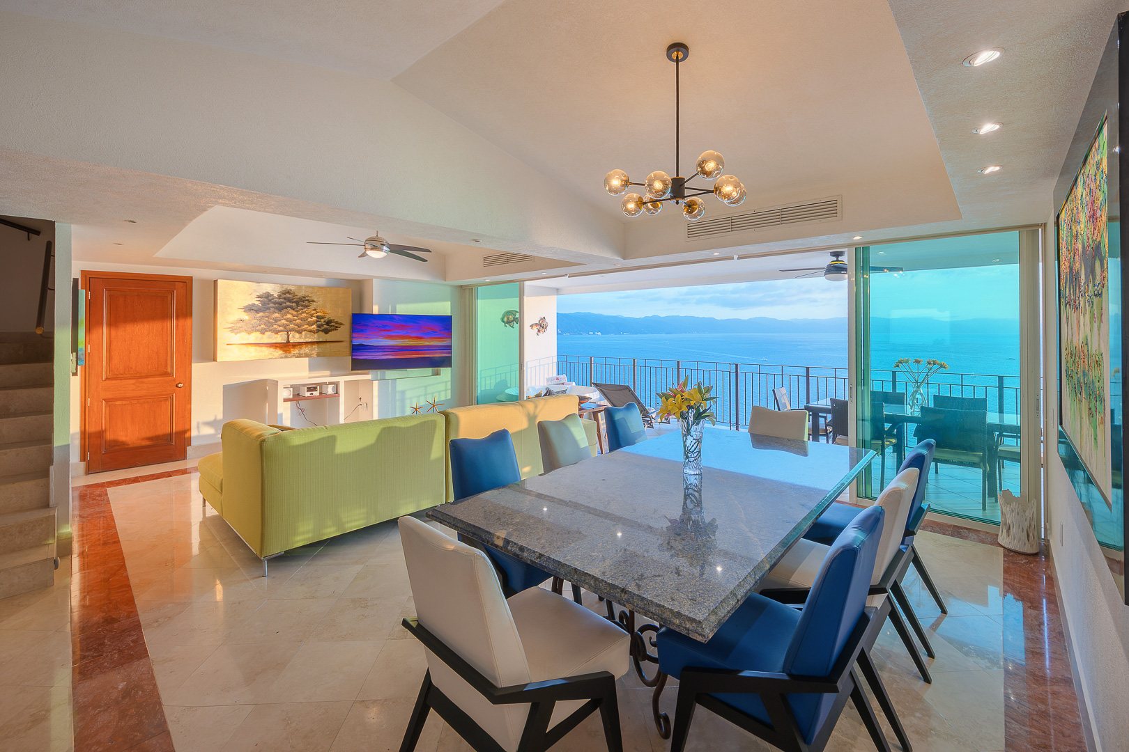 Dining area beside the great room, with the ocean beyond the glass