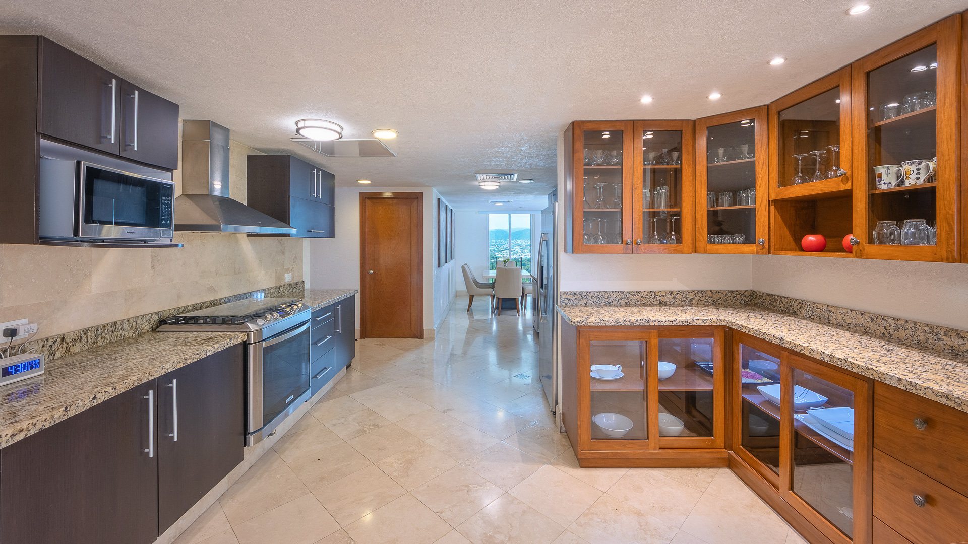 Kitchen with granite counters, a gas range and glass-front cabinets
