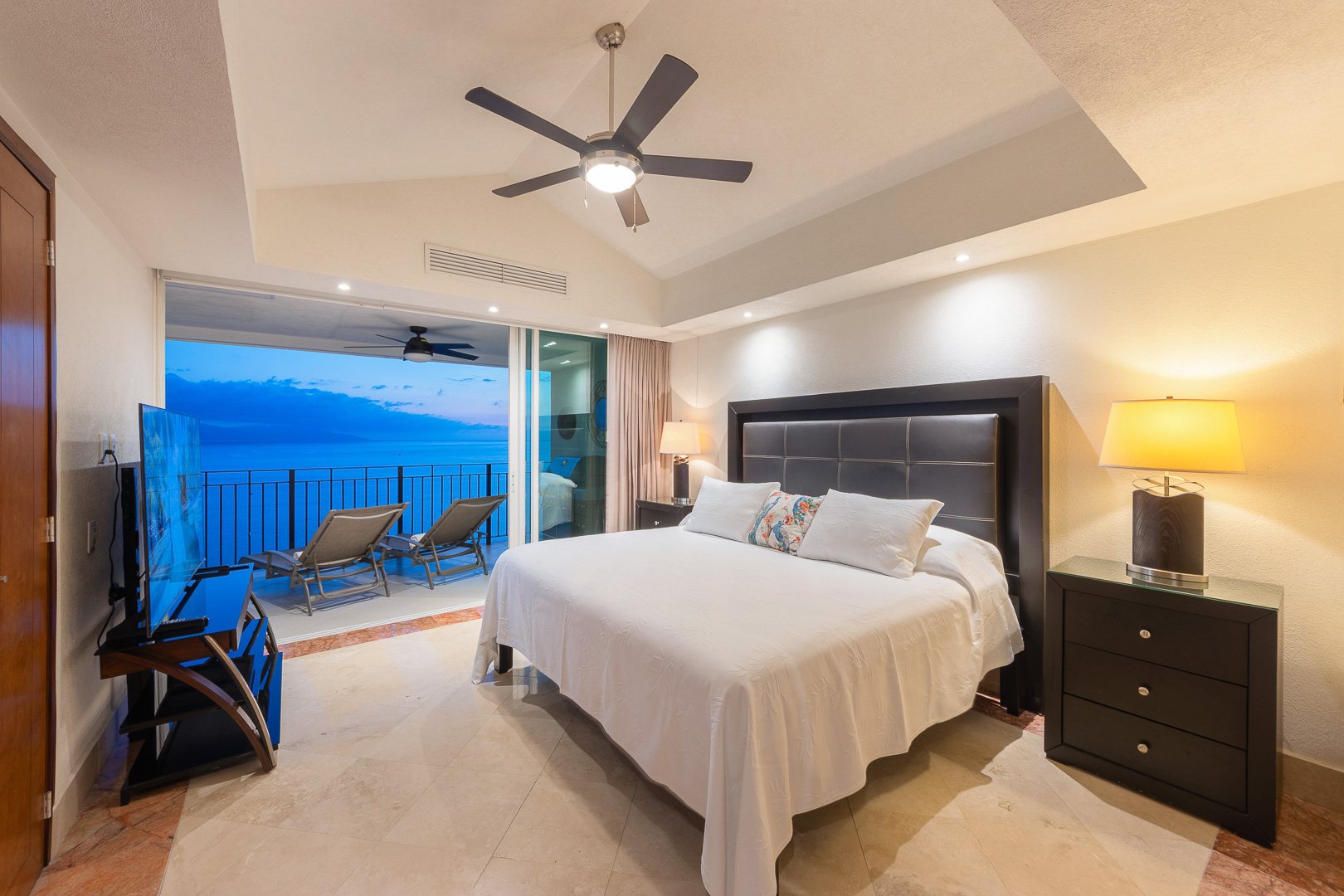 Bedroom opening to the terrace at dusk