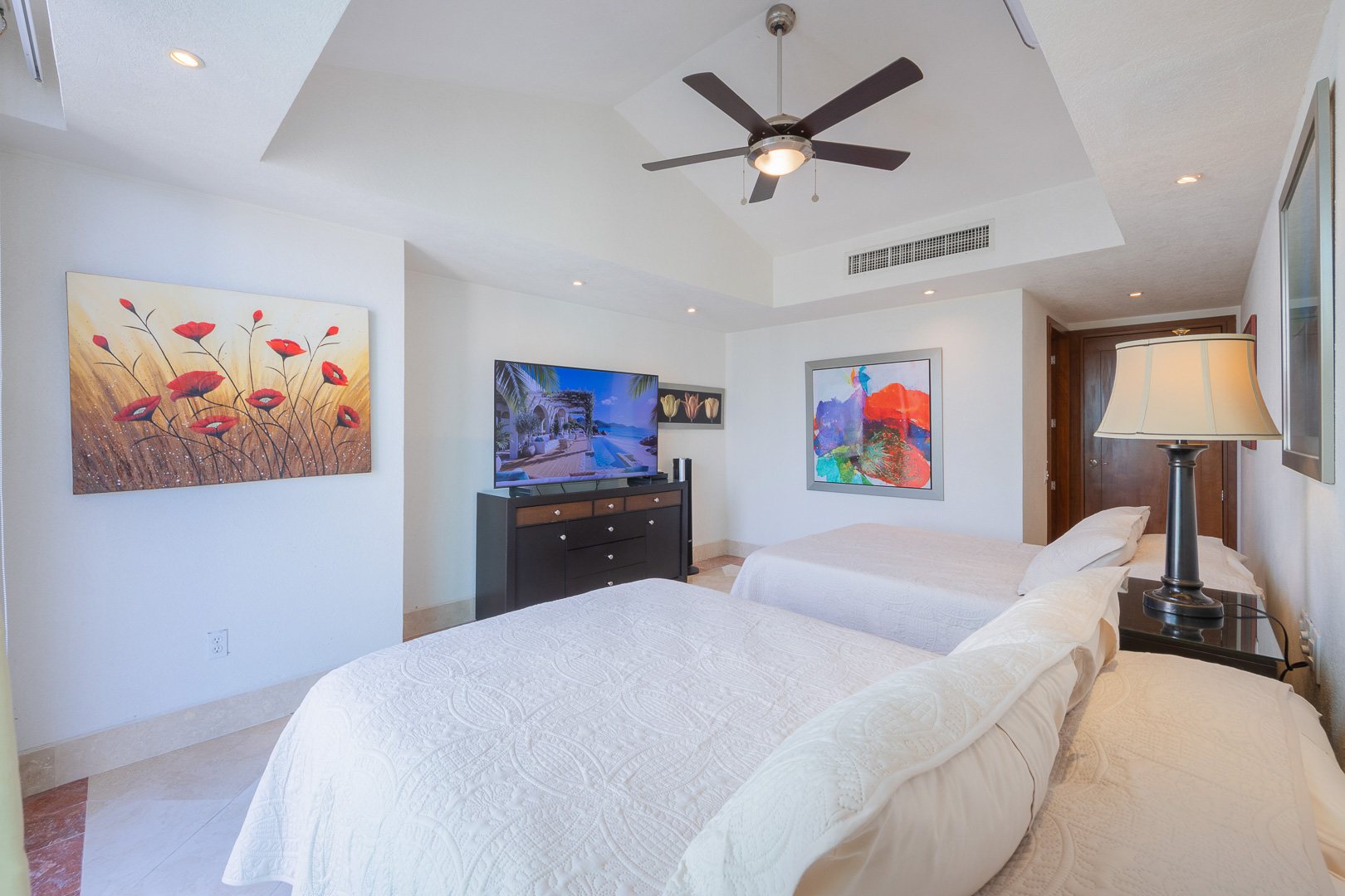 Bedroom with two beds and original artwork