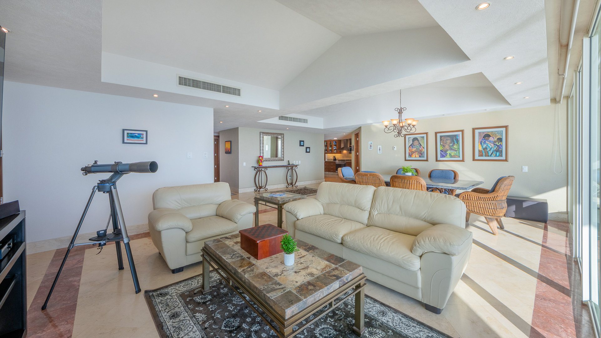 Great room with a telescope set toward the bay