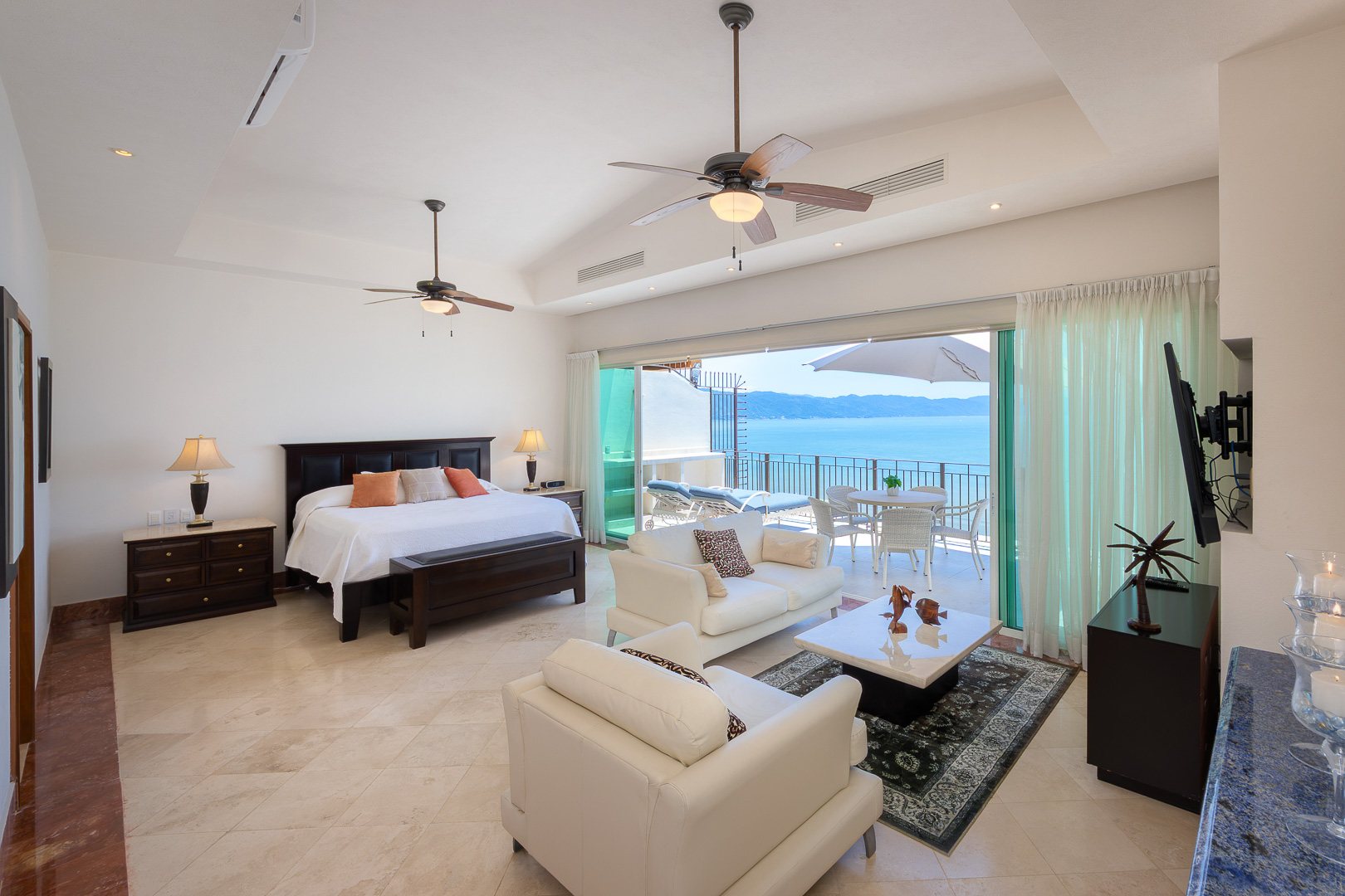 Primary suite bed and sitting area