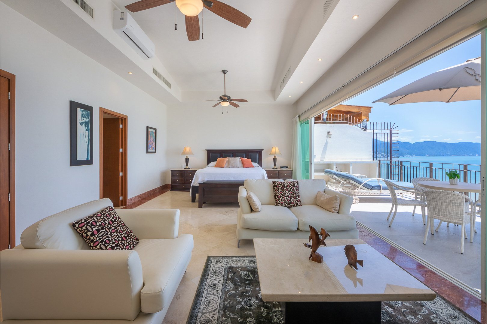 Primary suite with the private terrace and the bay beyond