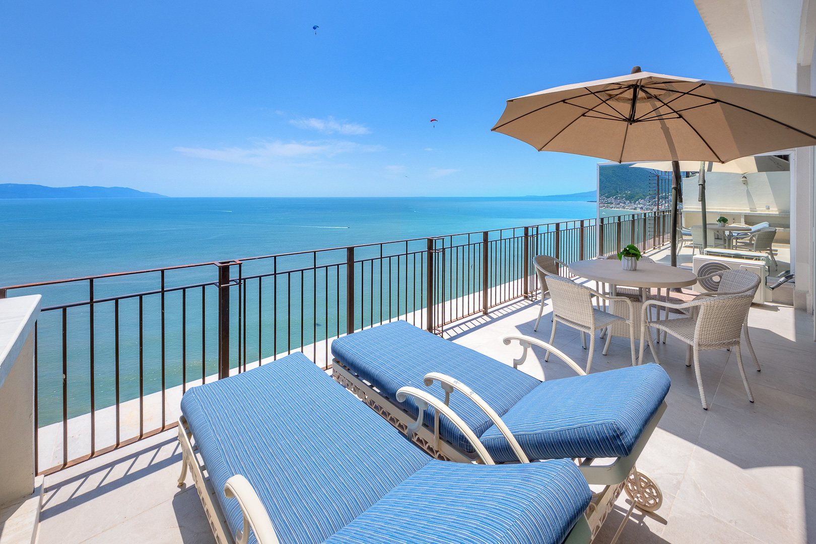 Loungers on the primary suite terrace above the bay
