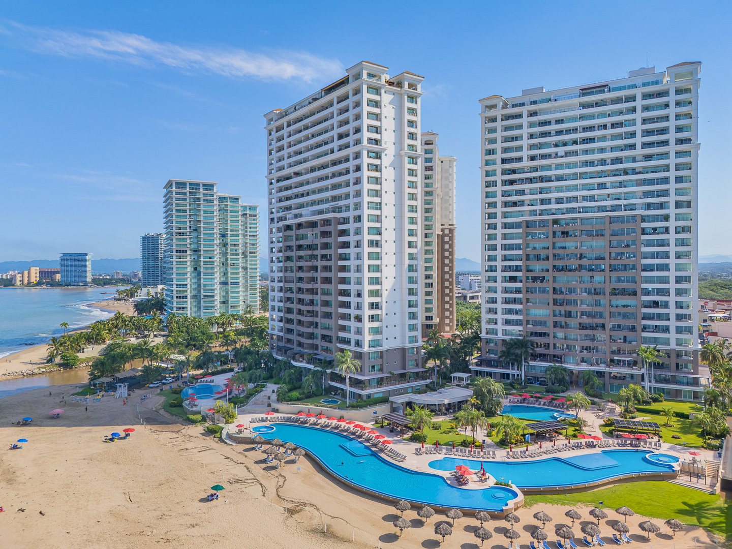 Aerial view of the Grand Venetian towers and pools on the beach