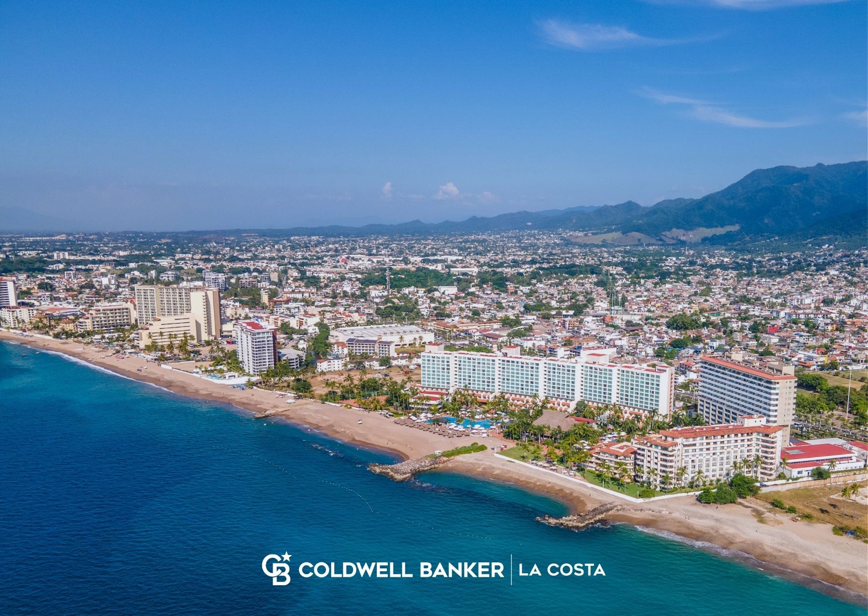 Aerial view of the Hotel Zone coastline and beachfront condominium towers in Puerto Vallarta