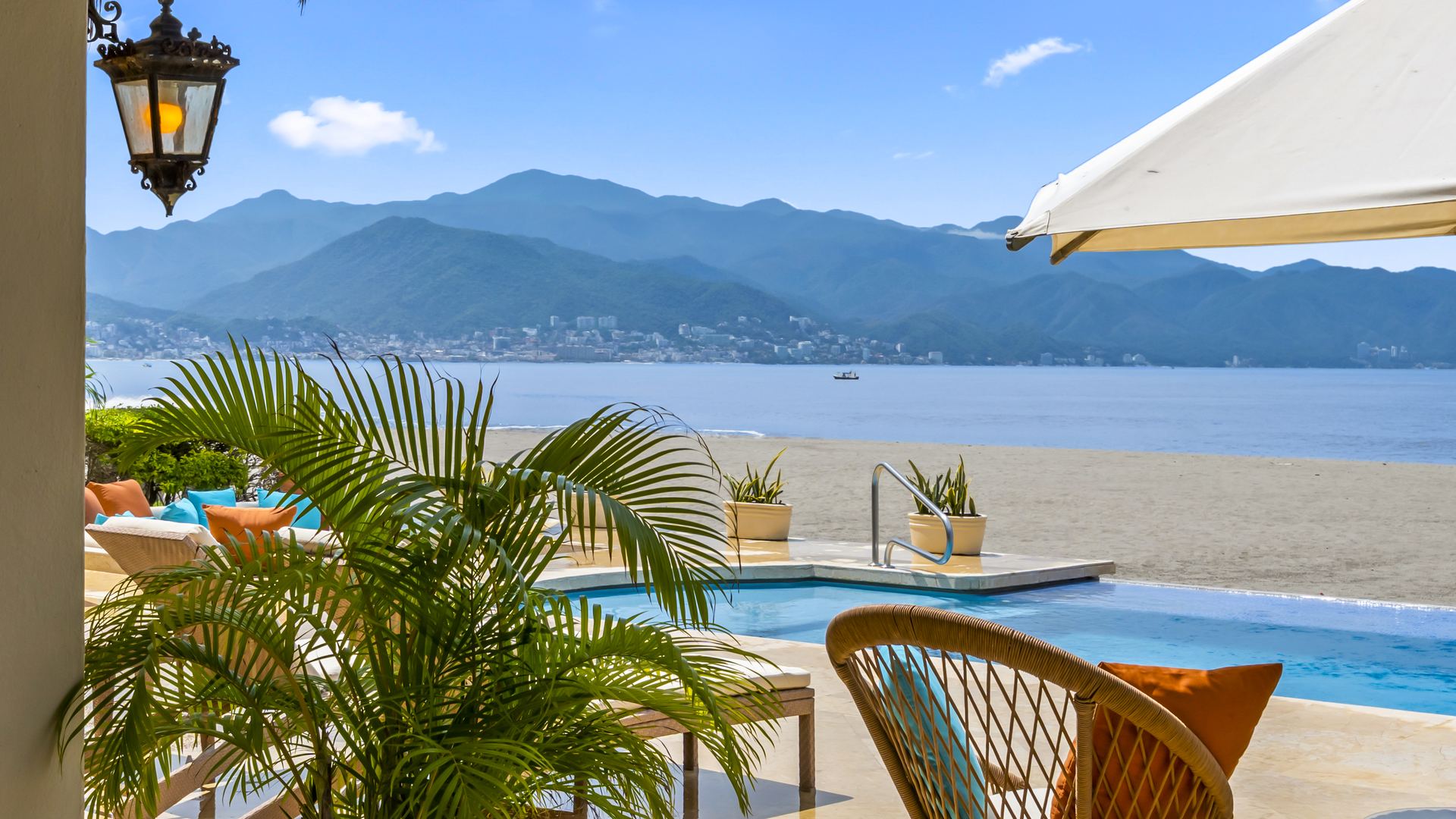 Private pool and sandy beach with Banderas Bay and the Sierra Madre beyond, seen from the terrace of Villa Caracoles 1A in Marina Vallarta
