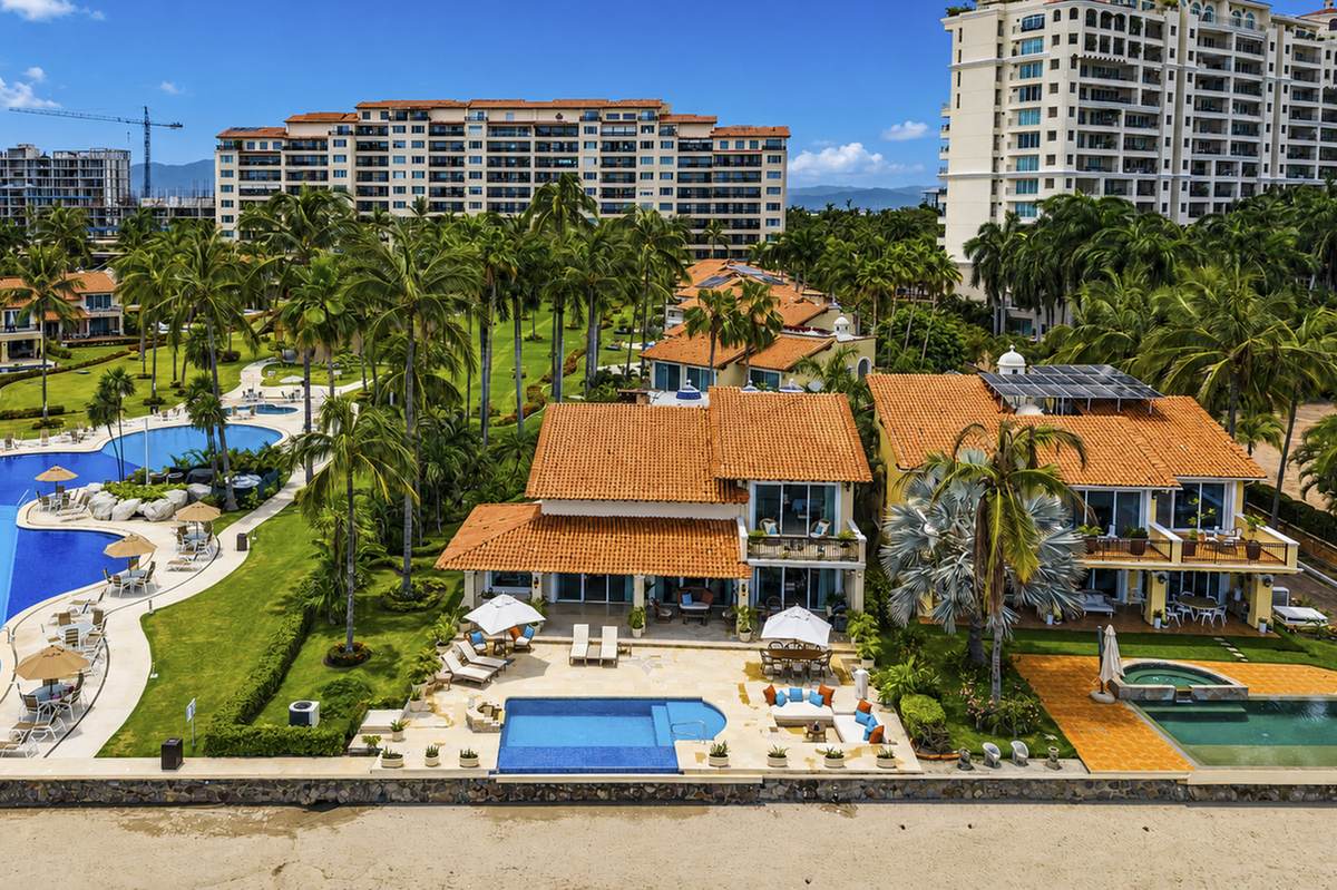 Aerial view of Villa Caracoles 1A, its private pool and lawn, beside the Condominios Caracoles pool
