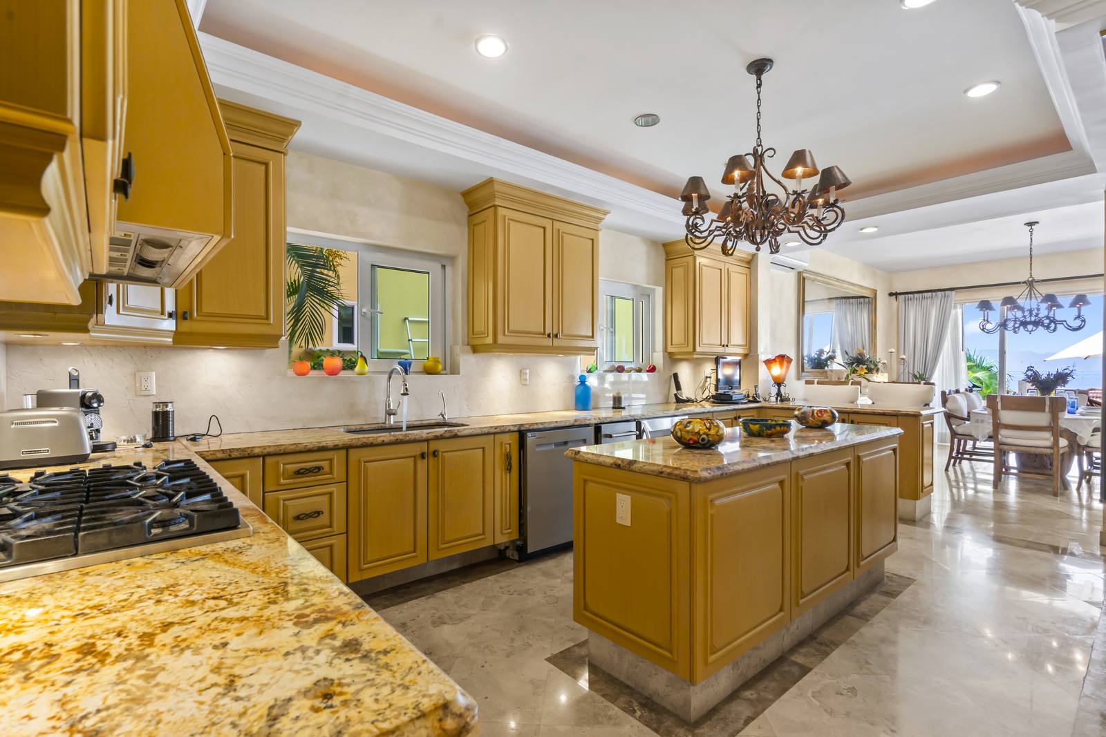 Kitchen with granite counters and center island, open to the dining area