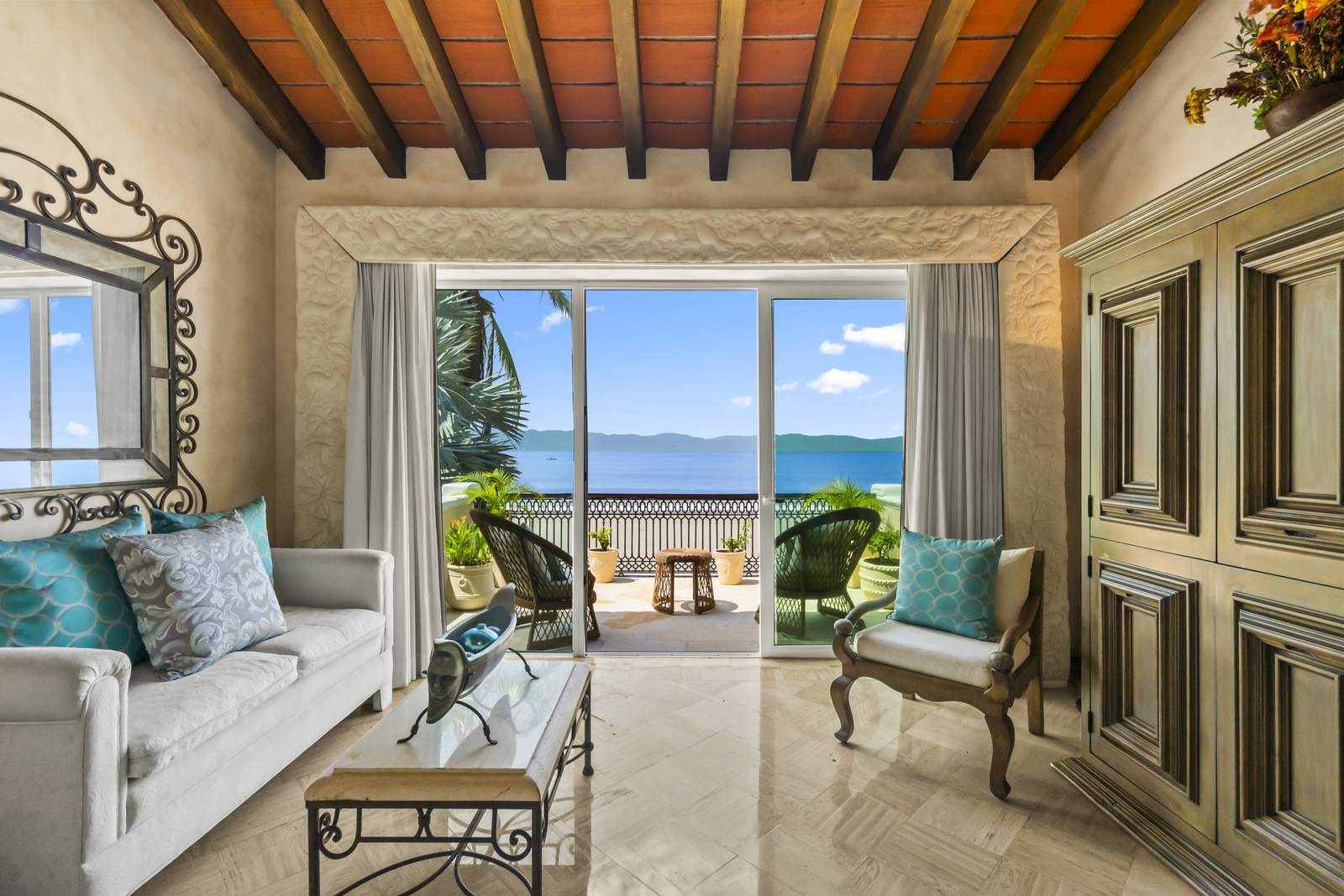 Primary suite sitting area opening to the terrace and the ocean