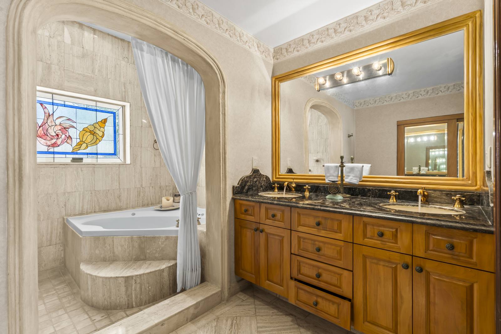 Primary bathroom with double vanity and jetted tub