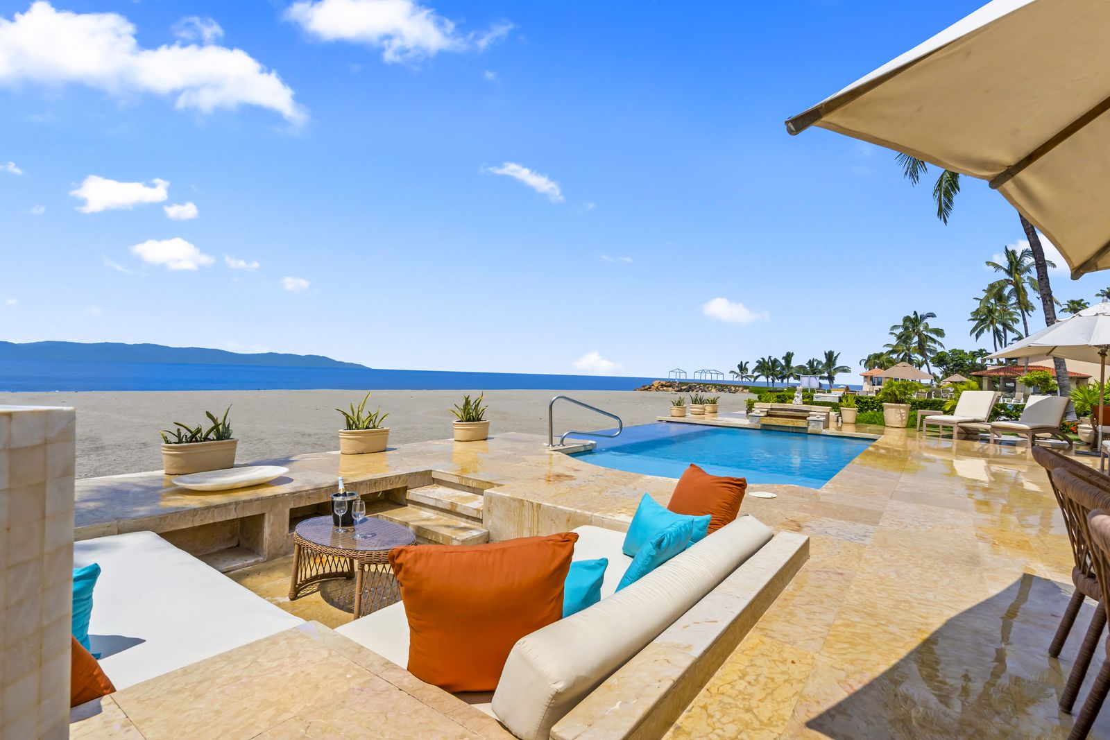 Sunken lounge beside the pool with the bay beyond