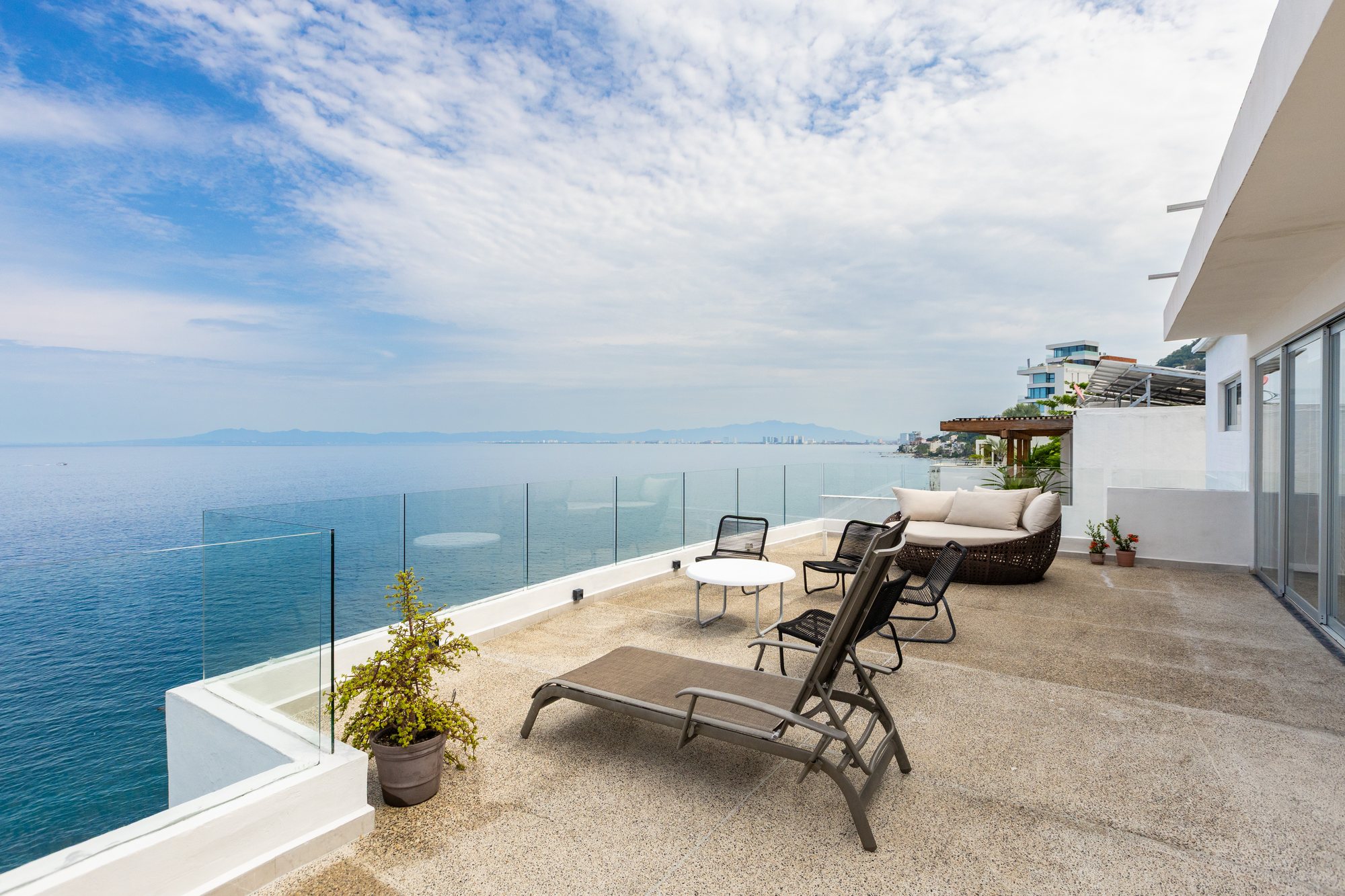 The penthouse upper terrace with loungers and an open view of Banderas Bay