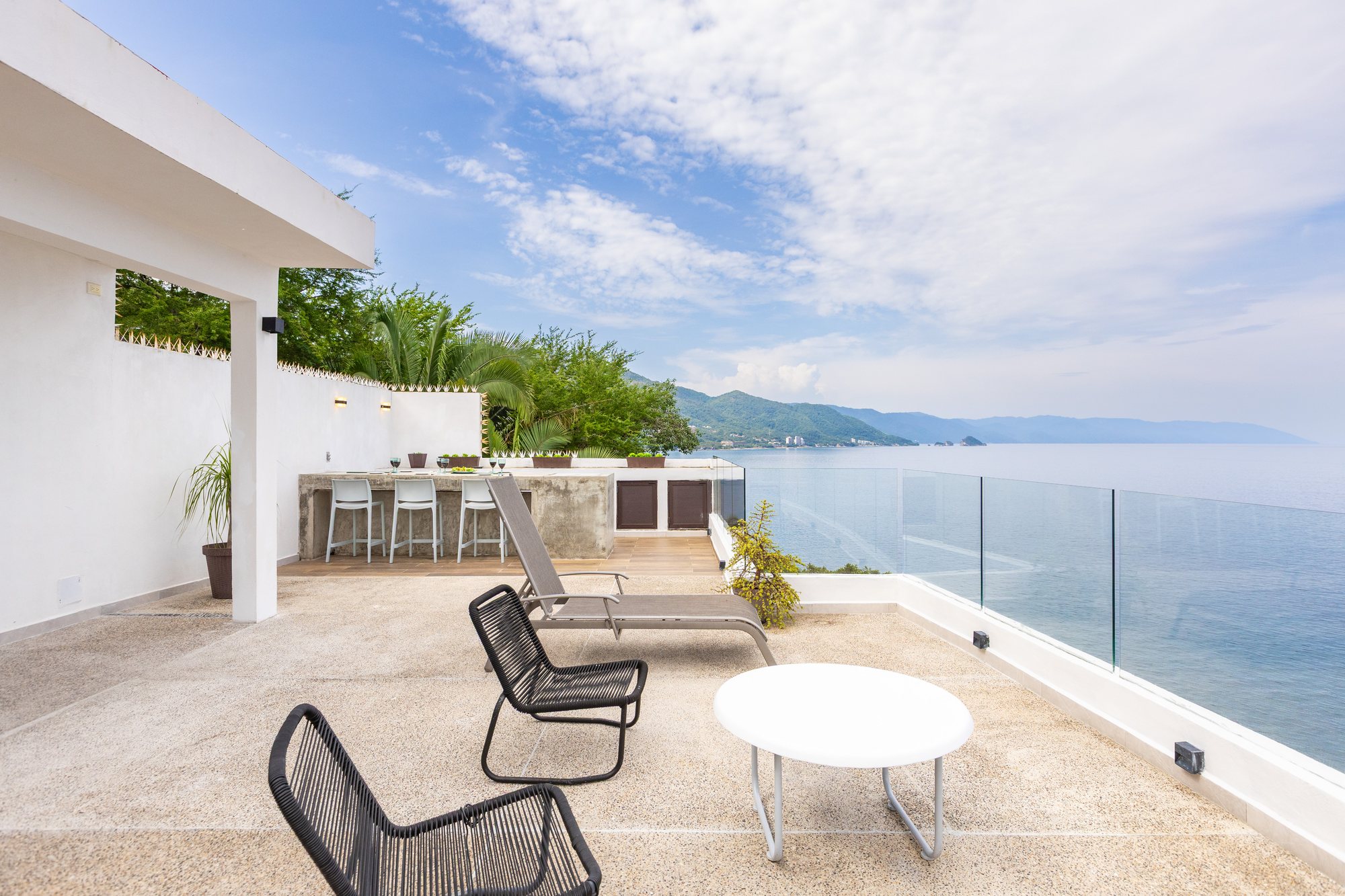 Lounge chairs on the upper terrace above the ocean