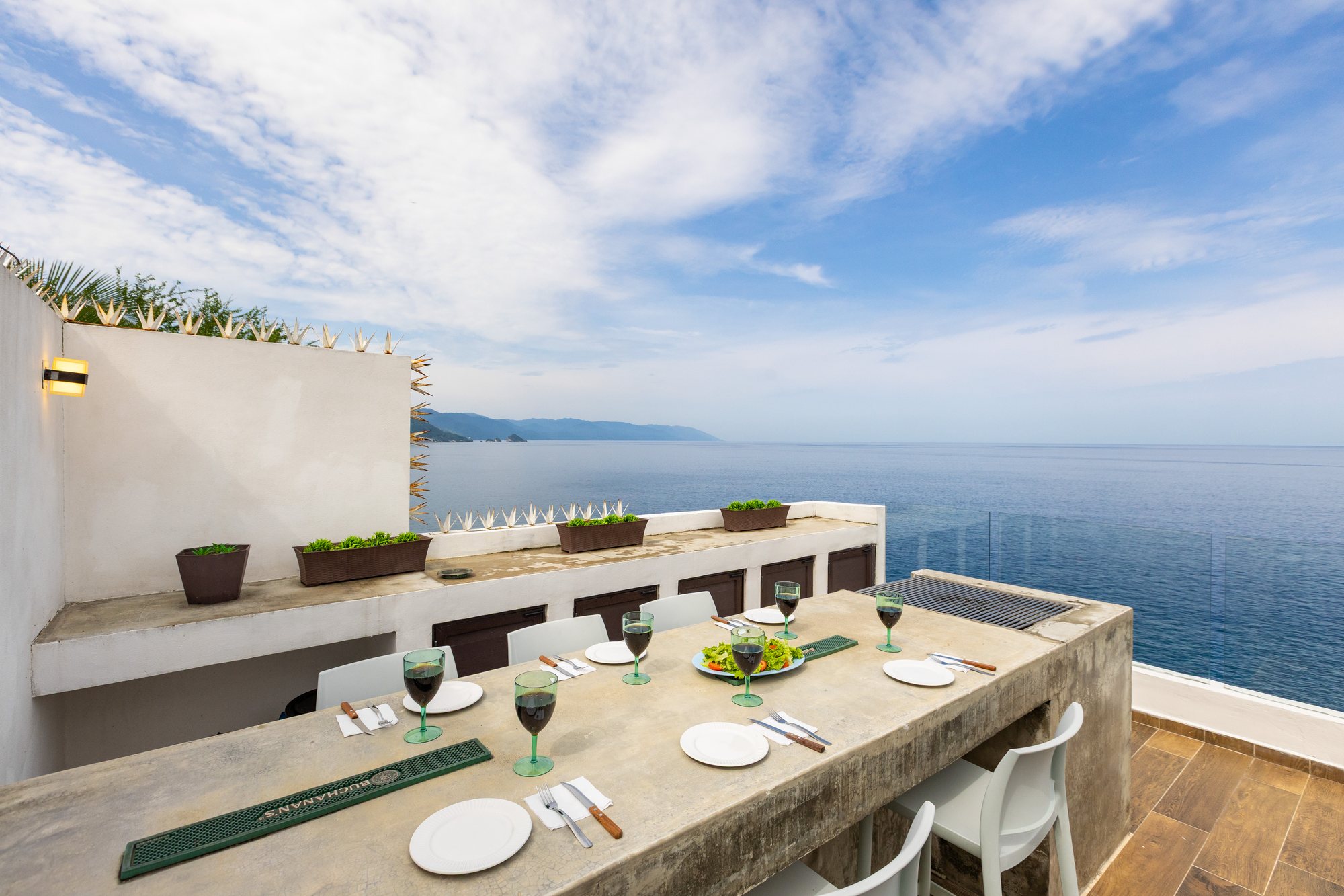 Outdoor dining counter on the upper terrace, facing the bay