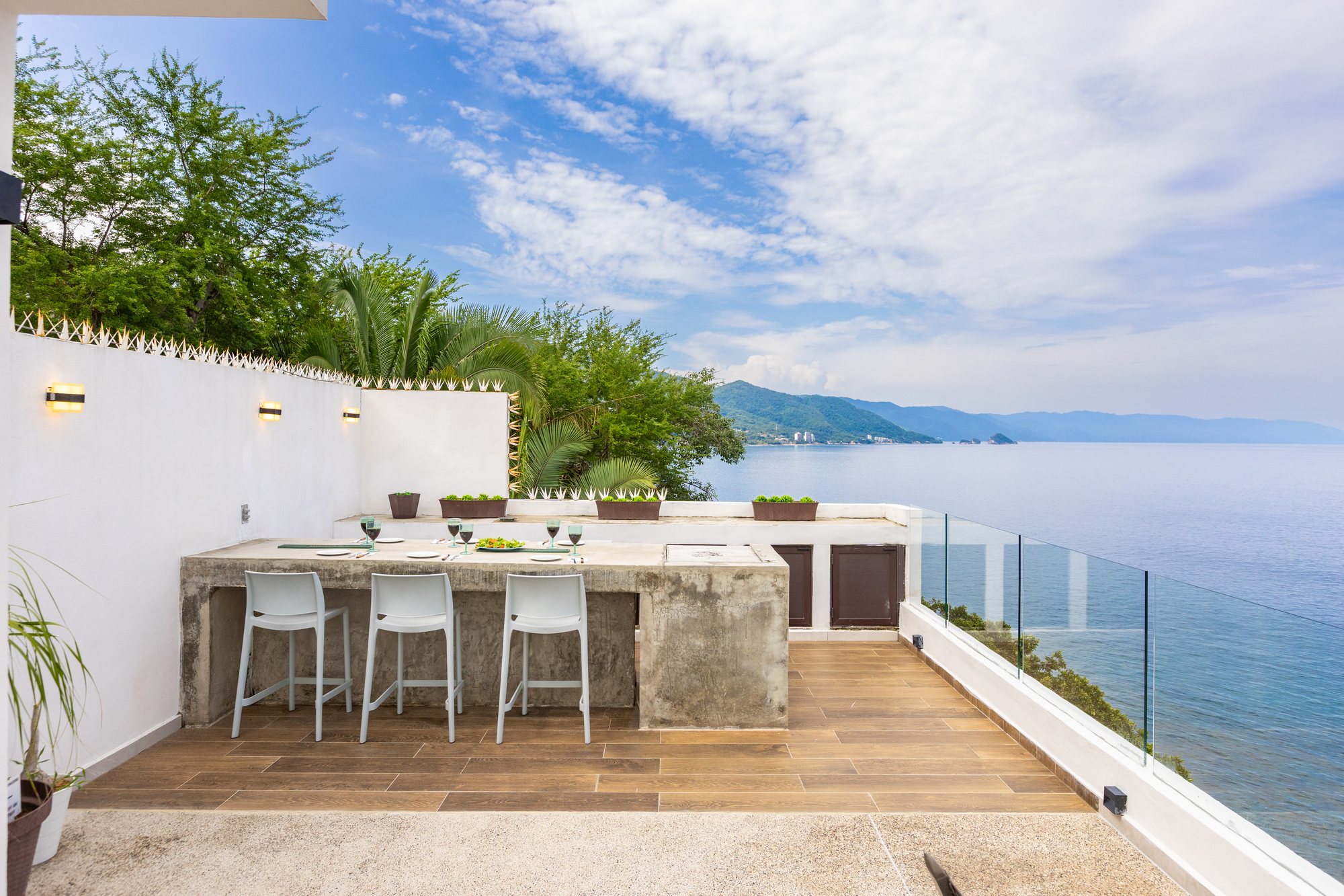 Terrace bar with stools, looking along the coast