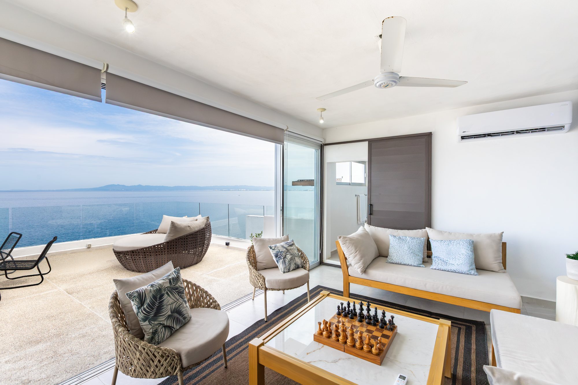 Upper-level lounge opening fully to the terrace