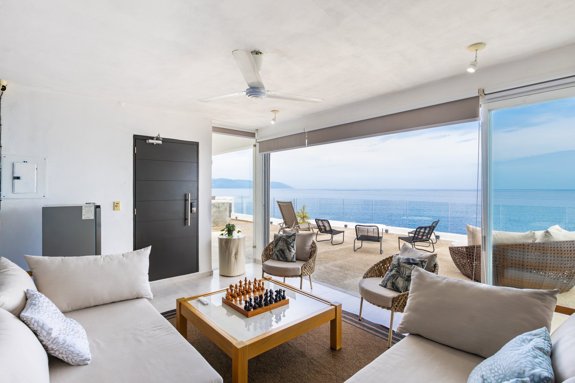 Upper-level lounge with sofas and a view of the bay