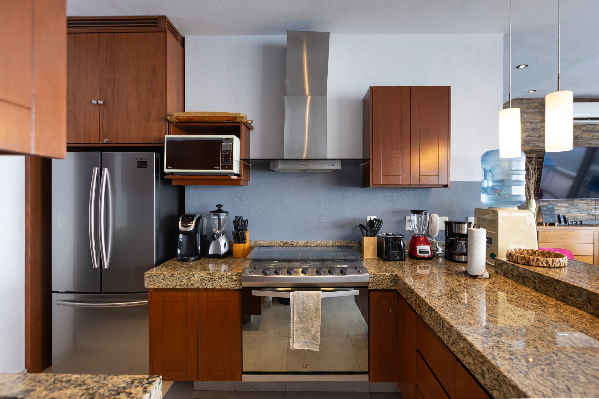 Kitchen with granite counters, a gas range and stainless appliances