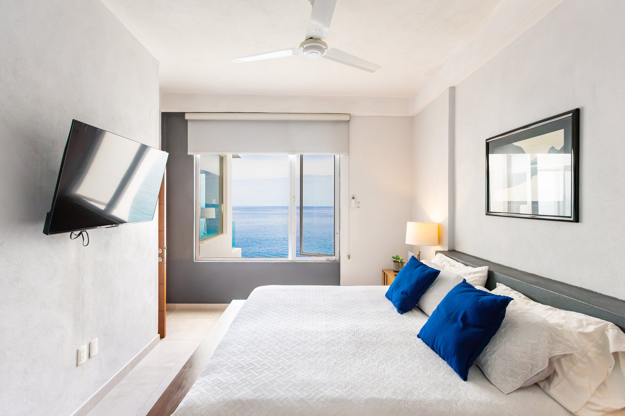 Bedroom with a king bed and an ocean view