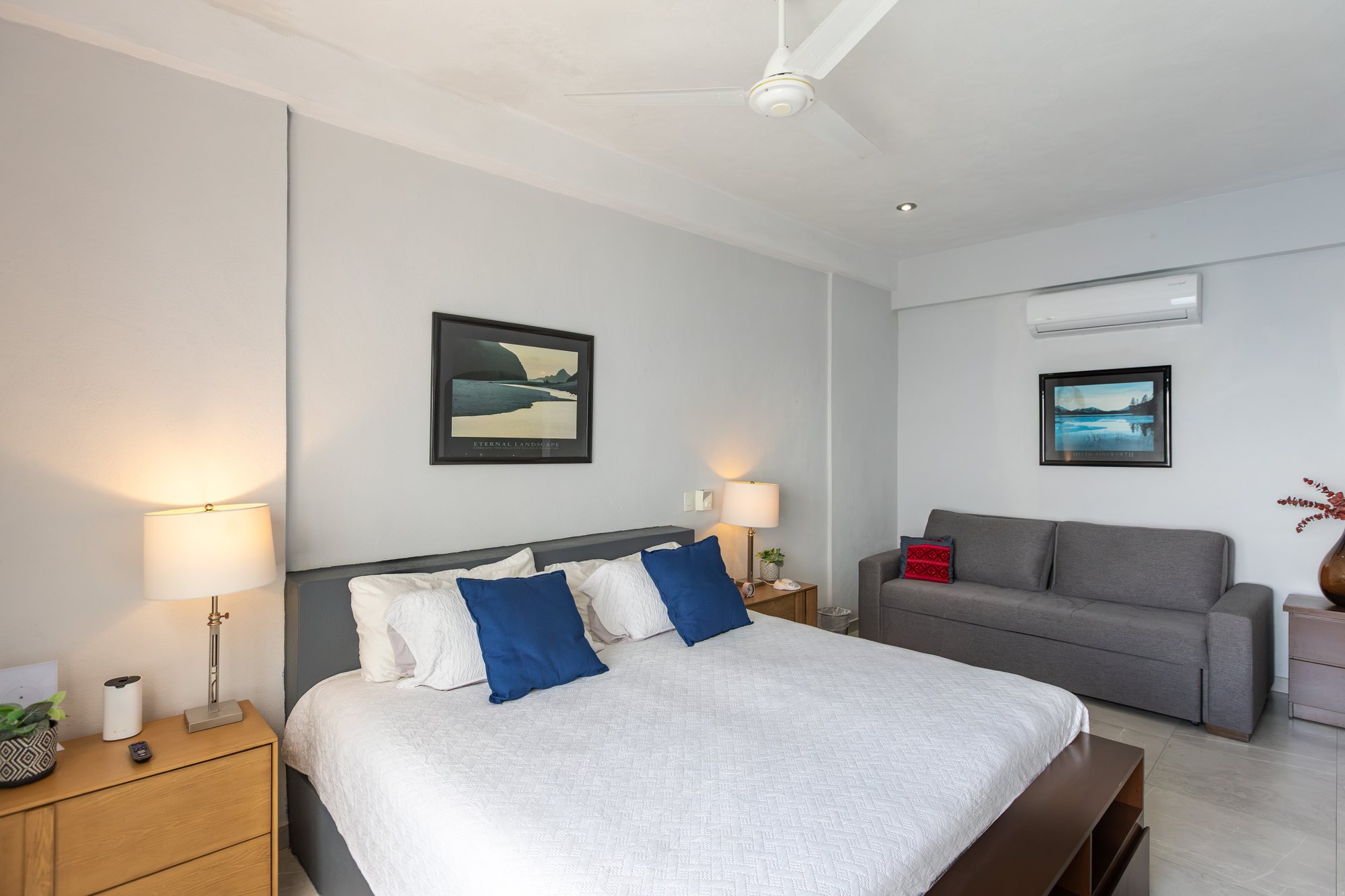 Bedroom with a sofa and reading lamps
