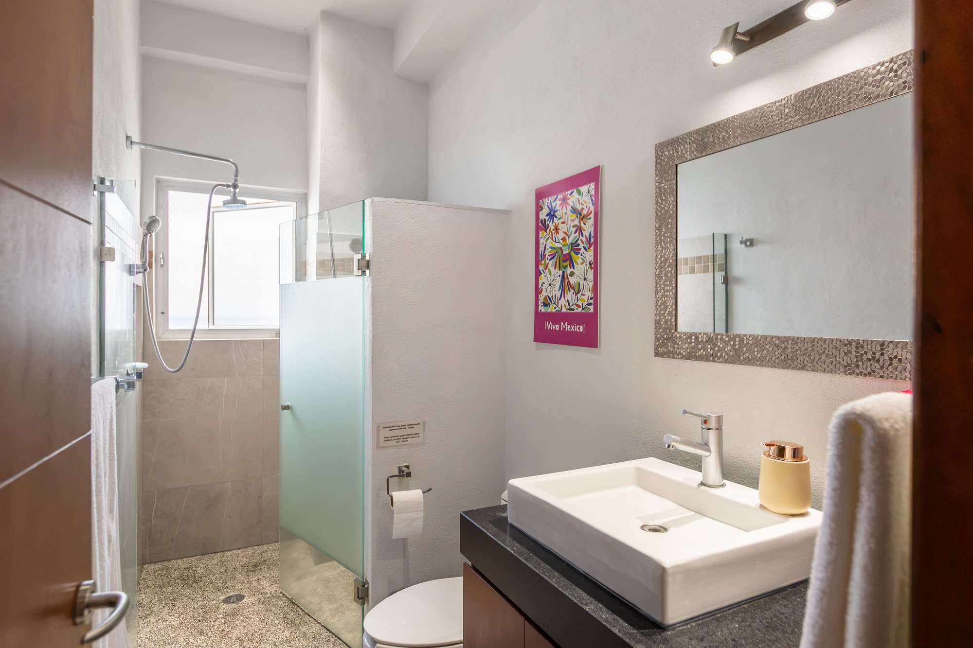 Bathroom with a framed mirror and vessel sink
