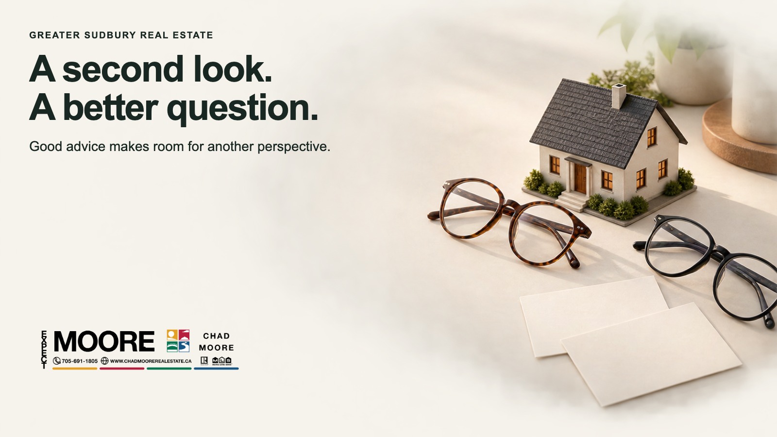 A model home beside two pairs of glasses with the words A second look. A better question.