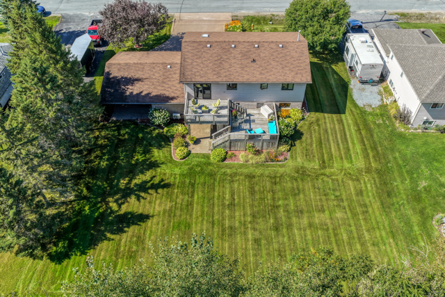 Overhead view of the rear yard, deck and tree line