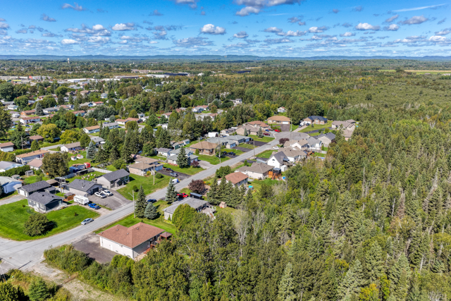 Wide aerial view of the neighbourhood and surrounding green space