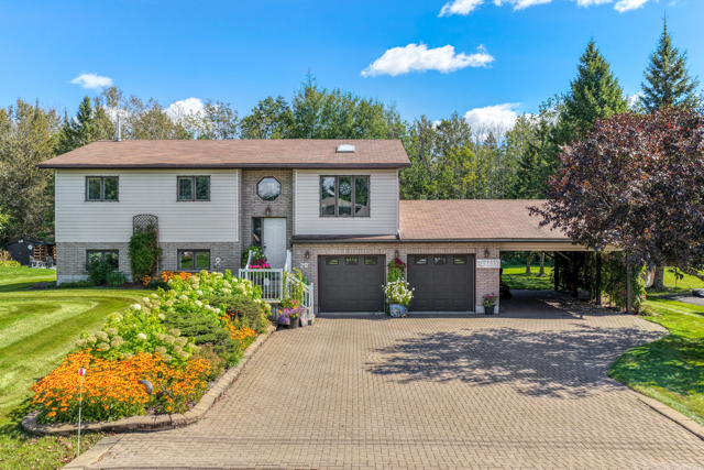 Front of 20 Hazel Street, landscaped beds, double garage and carport