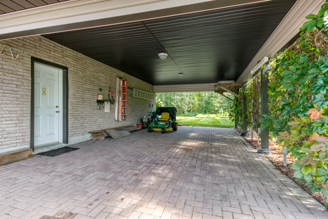 Sheltered carport with access beside the garage