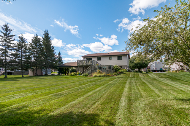 Long, striped lawn looking back toward the home