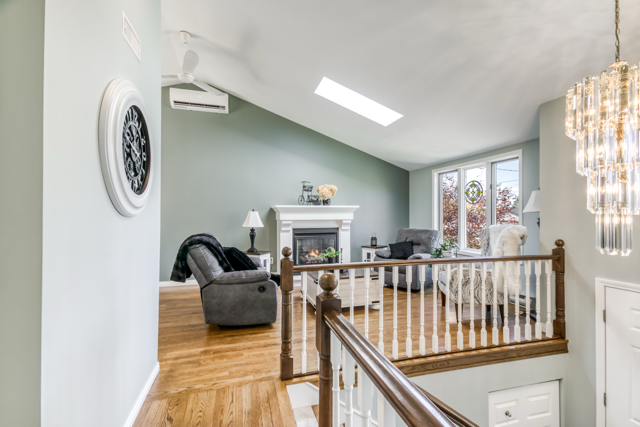 The main-floor living room, skylight and fireplace