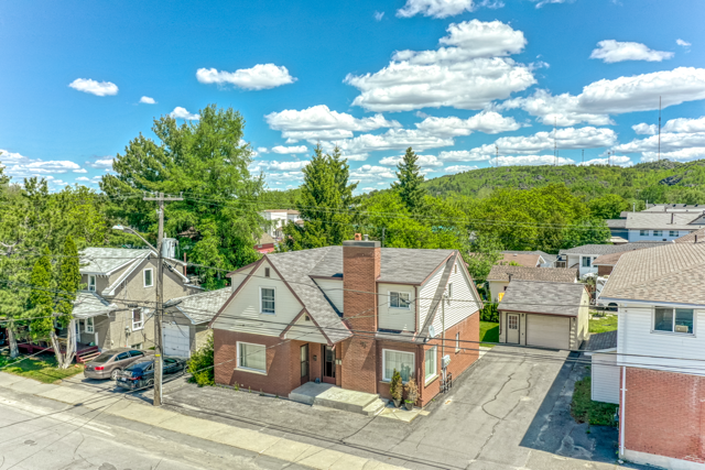 Elevated exterior view of the legal triplex, driveway and detached garage at 488 Clinton Avenue