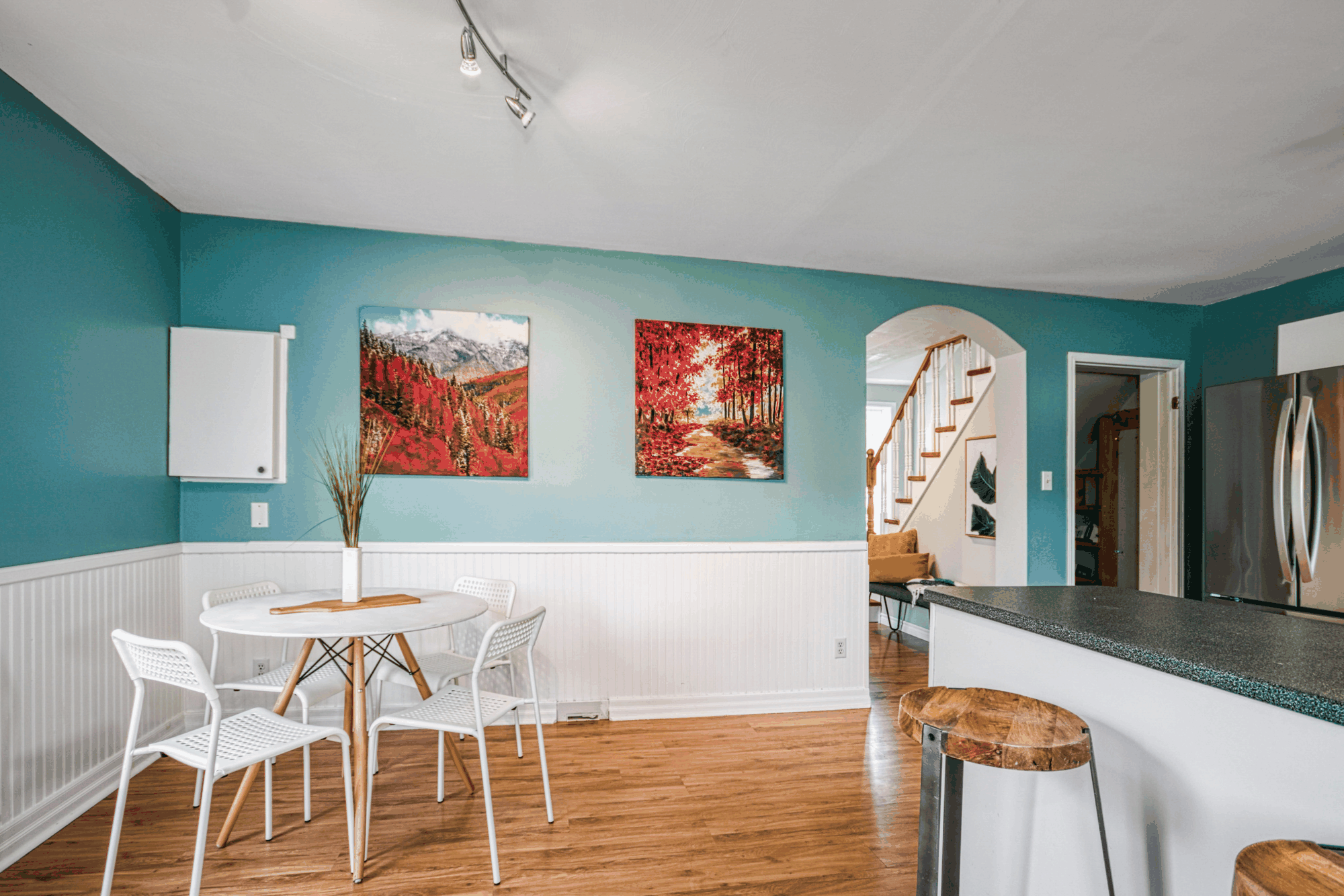 Open kitchen and dining area with white cabinetry