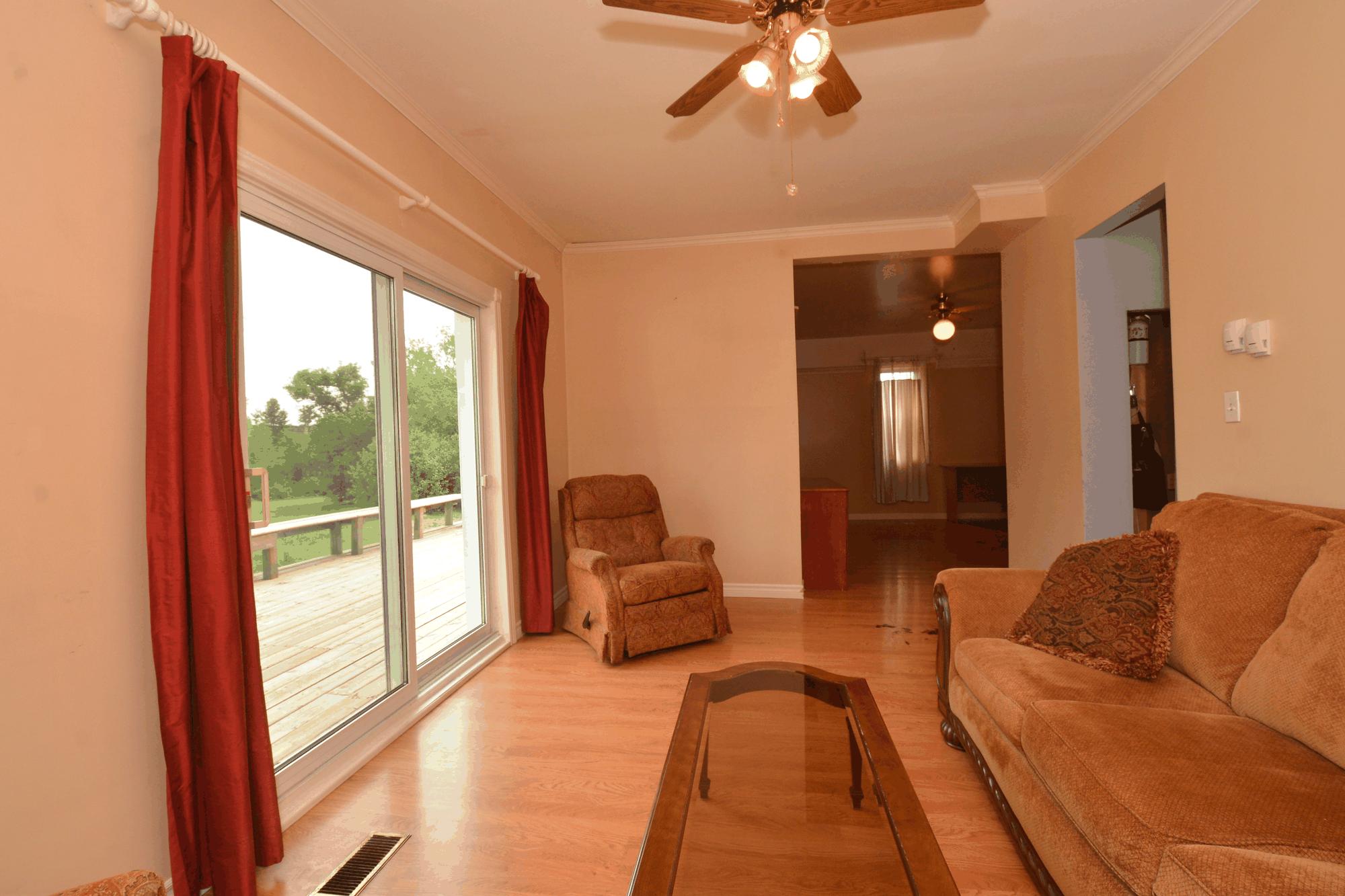 Living room with wood floor and sliding doors to the deck