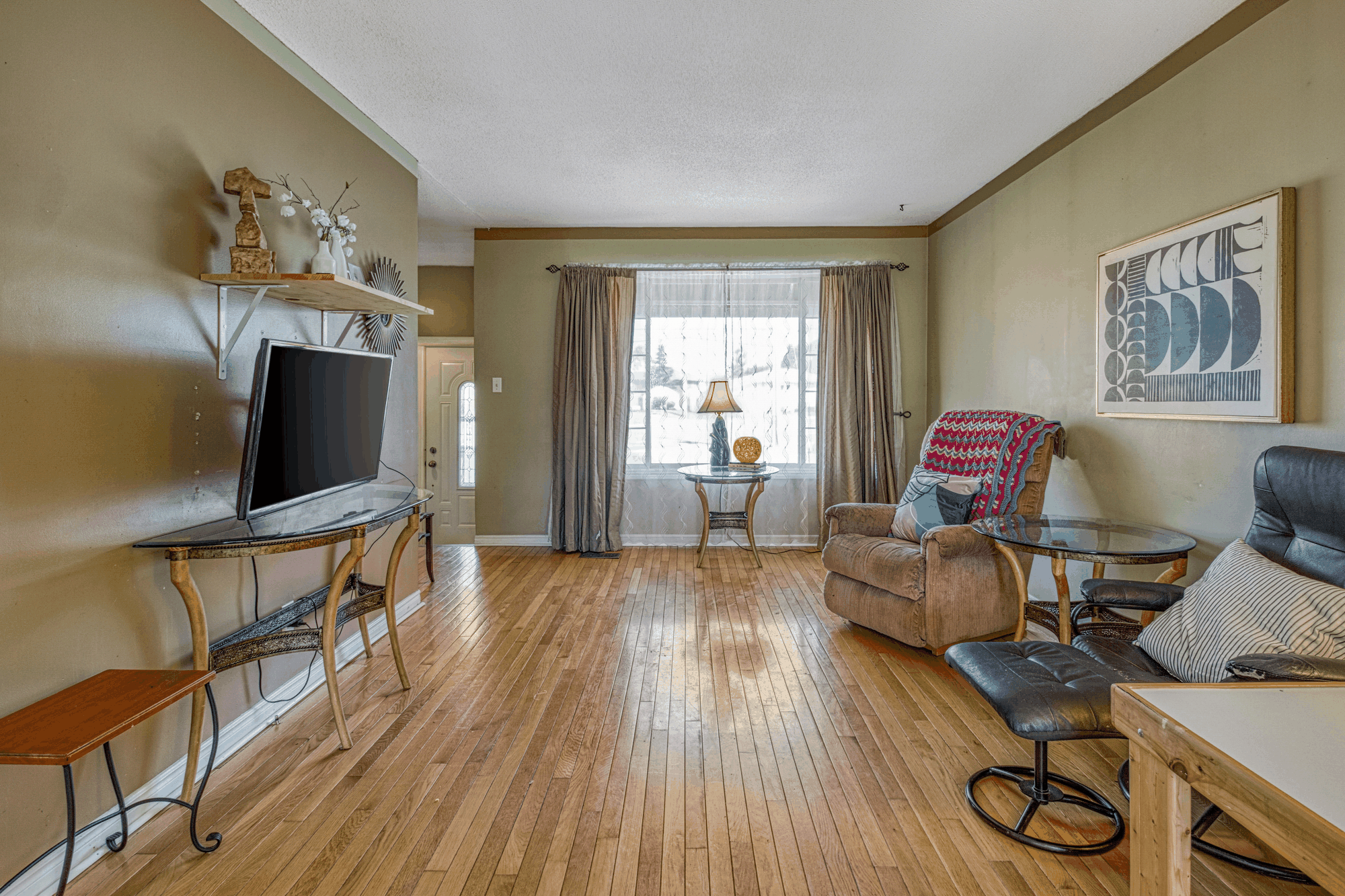 Living room with hardwood floor and front window