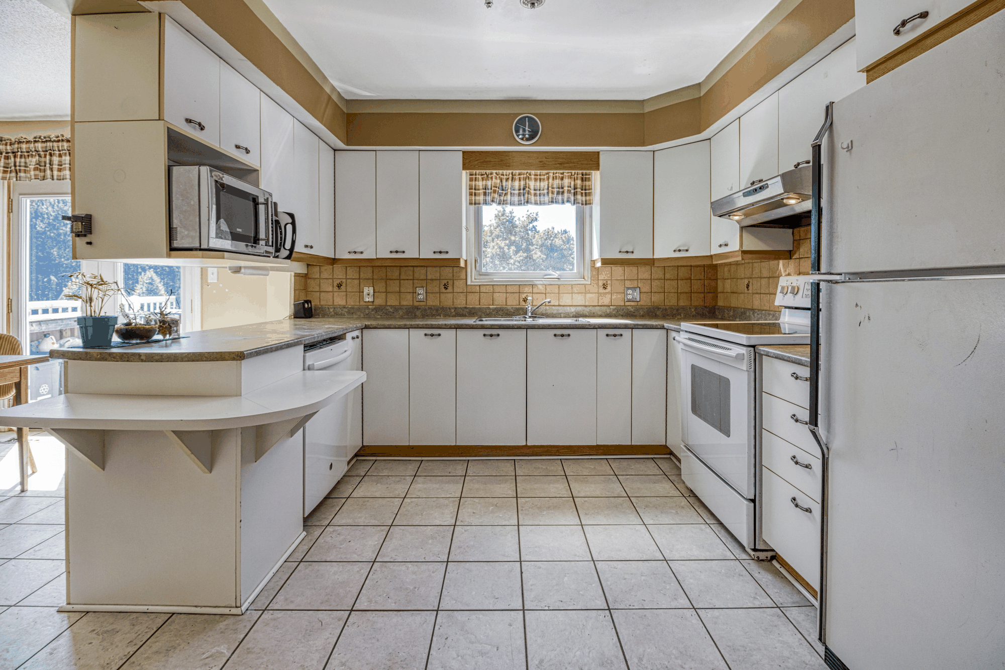 Kitchen and dining area with white cabinetry
