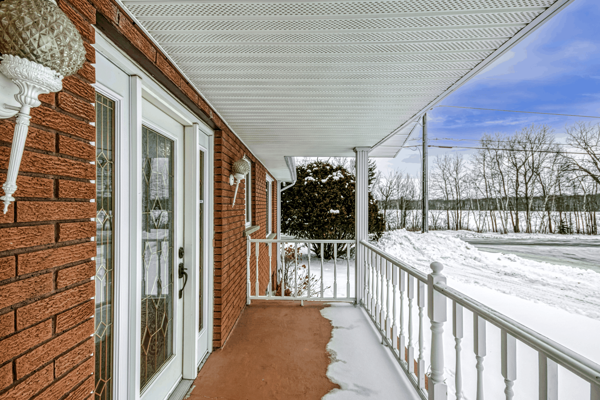 Covered rear porch overlooking the snowy yard