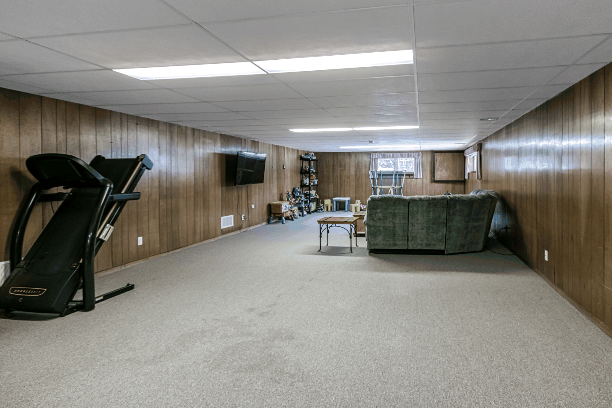 Wide finished lower-level recreation room