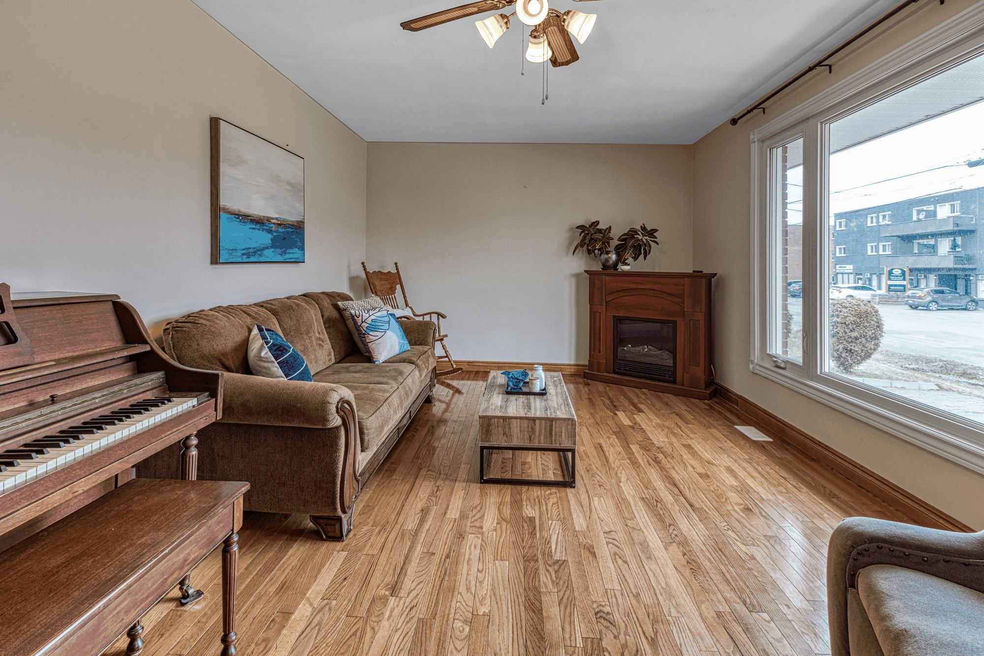 Living room with large front window and hardwood floor